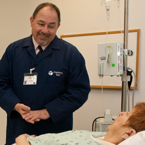 Chaplain Robert Henderson meets with a patient