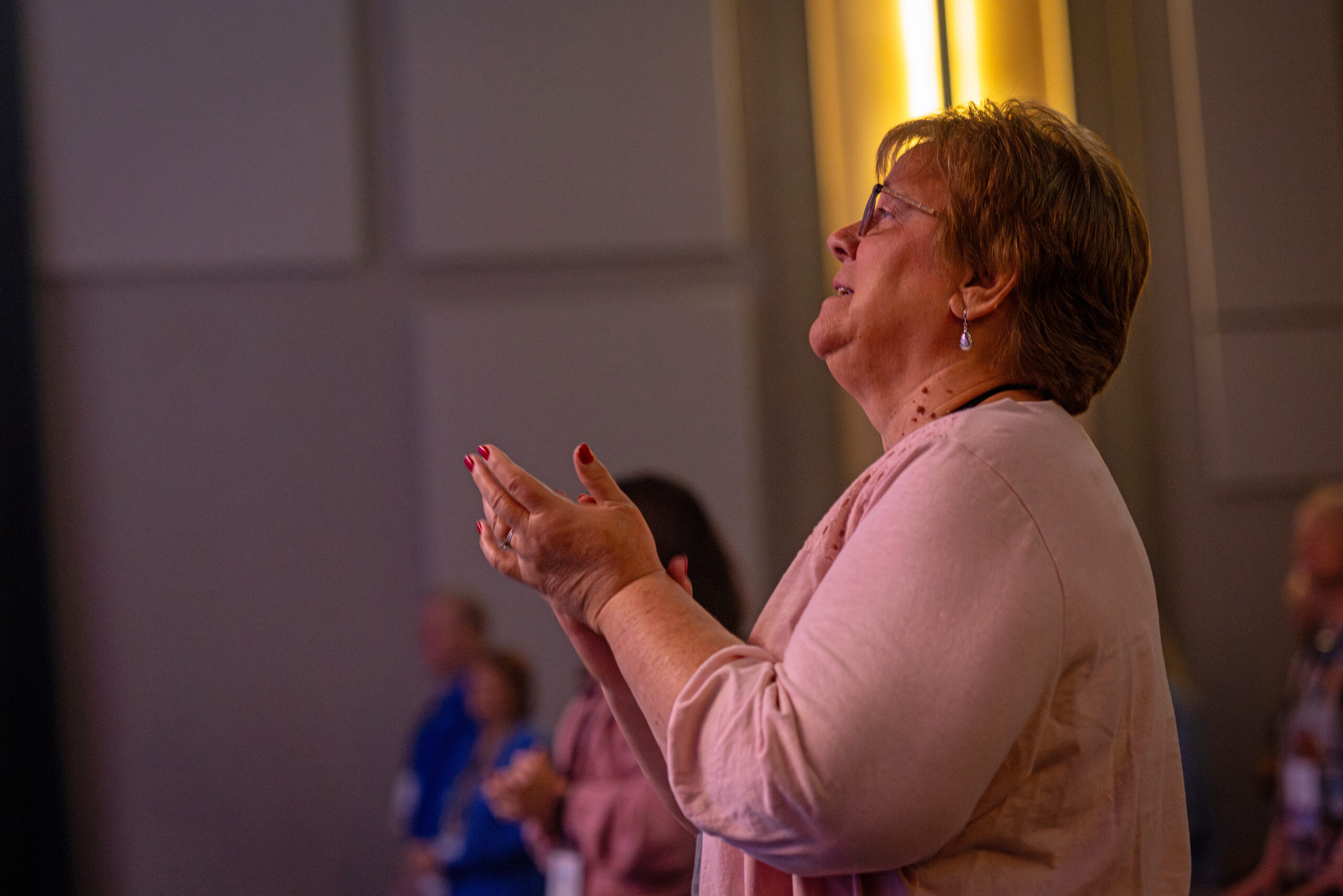 female worshipping in service